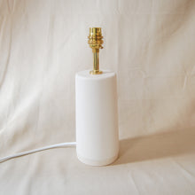 Load image into Gallery viewer, white lamp base with brass fitting and white power cord on a neutral background
